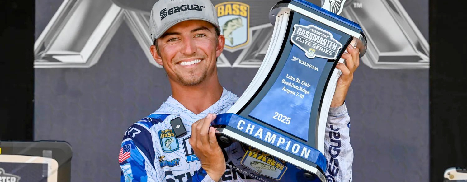 Photo of Trey McKinney holding the 1st Place Bassmaster Elite Series trophy for his win at Lake St. Clair in 2025.
